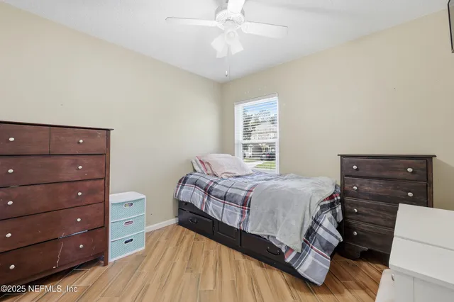 a view of bedroom with furniture and wooden floor
