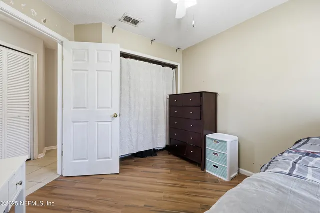a bathroom with a granite countertop sink a large mirror and a bathtub
