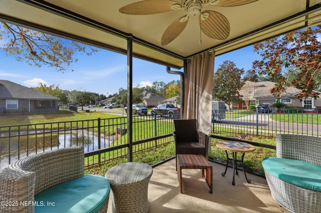 a view of a house with a small yard and wooden fence