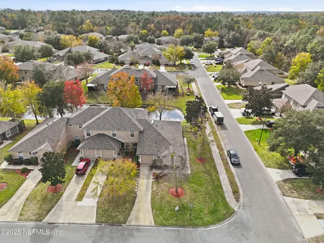 an aerial view of a house with a swimming pool