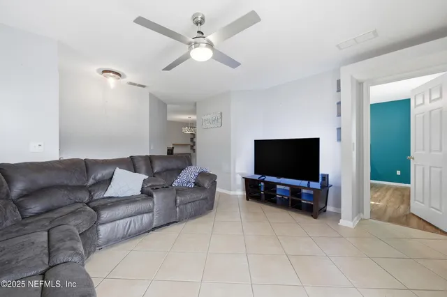 a living room with furniture and a flat screen tv