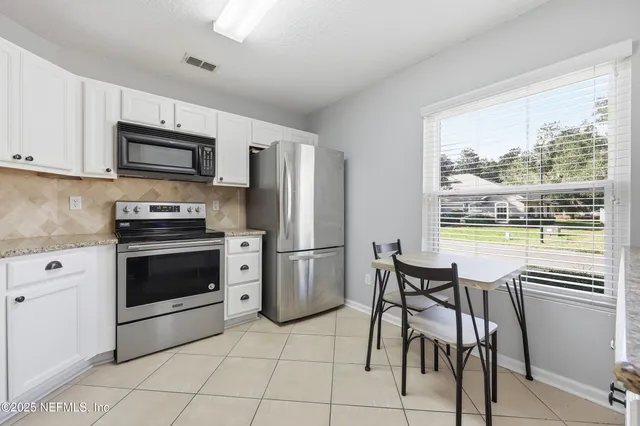 a kitchen with a stove a sink and a refrigerator