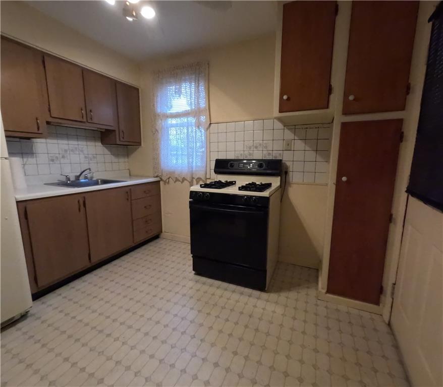 1813 Freeport Road Natrona Heights, PA 15065 - Photo 3 of 19 a kitchen with stainless steel appliances granite countertop a stove a refrigerator and a sink