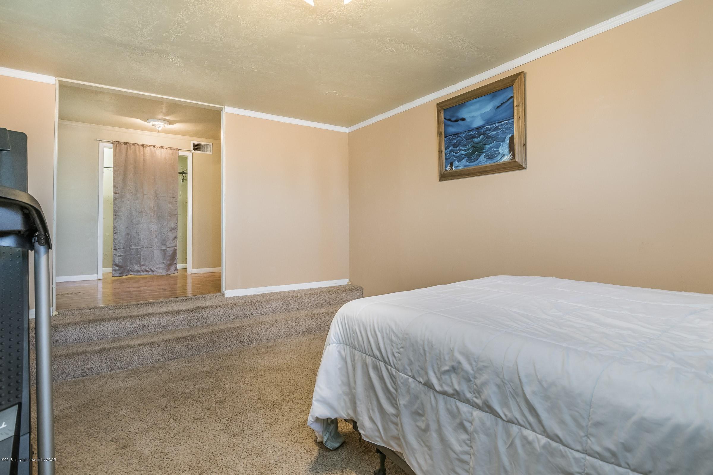 4635 South Hughes Street Amarillo, TX 79110 - Photo 11 of 20 a bedroom with a bed and a painting on the wall