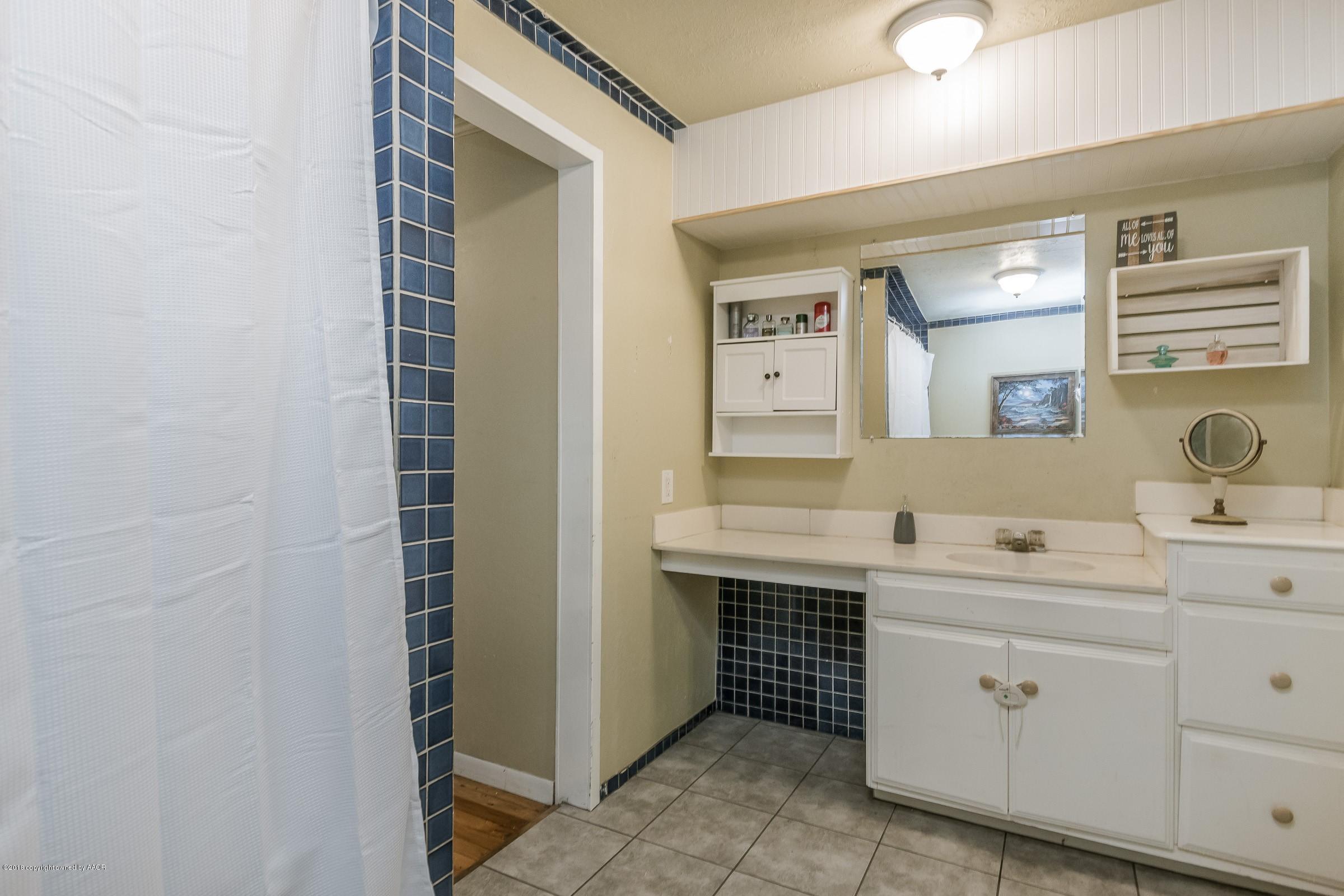 4635 South Hughes Street Amarillo, TX 79110 - Photo 12 of 20 a spacious bathroom with a double vanity sink a mirror and a