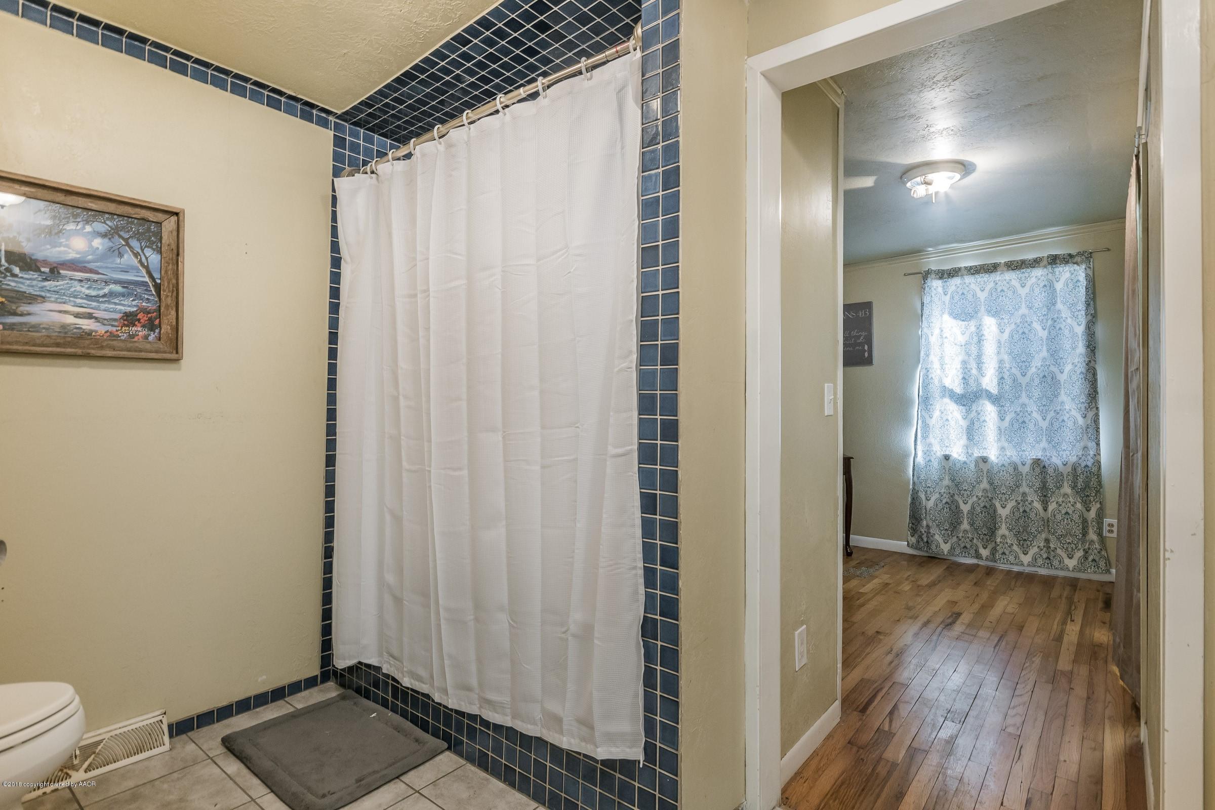 4635 South Hughes Street Amarillo, TX 79110 - Photo 13 of 20 a view of a room with wooden floor and windows