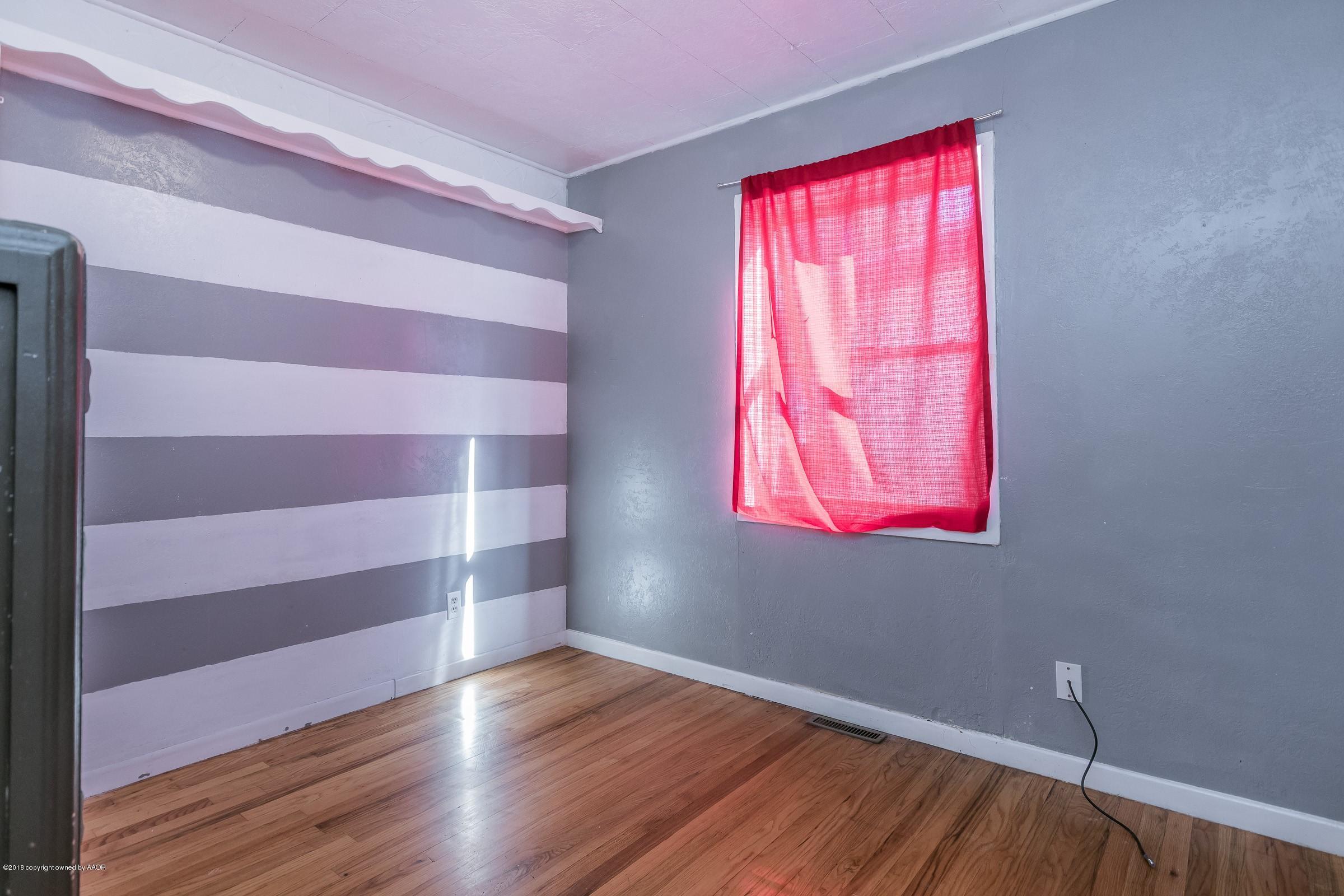 4635 South Hughes Street Amarillo, TX 79110 - Photo 15 of 20 a view of a room with wooden floors and window