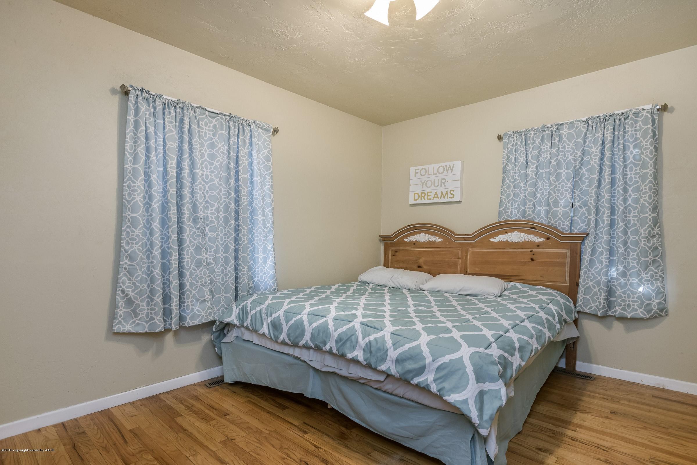 4635 South Hughes Street Amarillo, TX 79110 - Photo 17 of 20 a bedroom with a bed and a window