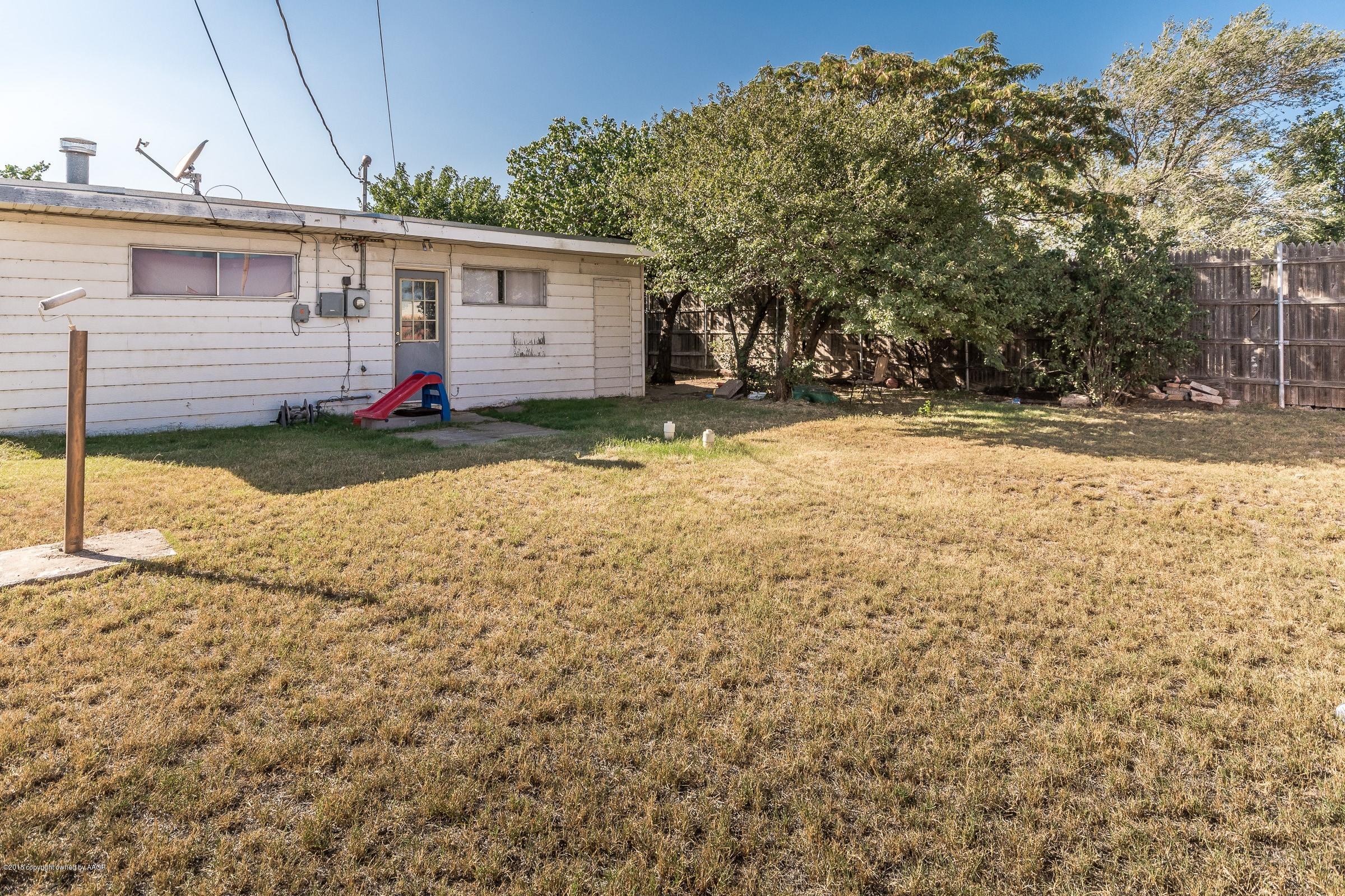 4635 South Hughes Street Amarillo, TX 79110 - Photo 20 of 20 a view of a backyard with a tree