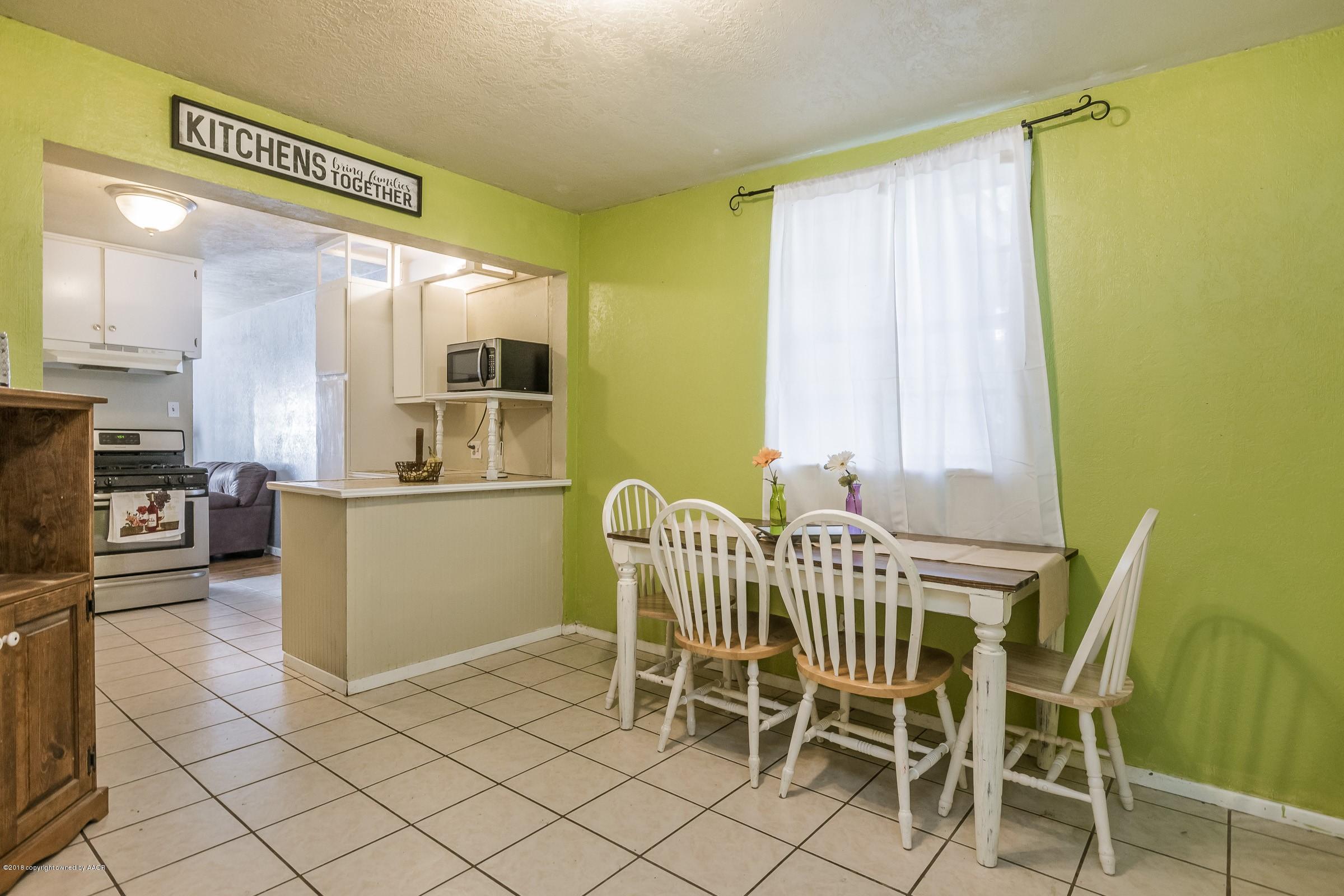4635 South Hughes Street Amarillo, TX 79110 - Photo 7 of 20 a view of a dining room with furniture and a chandelier