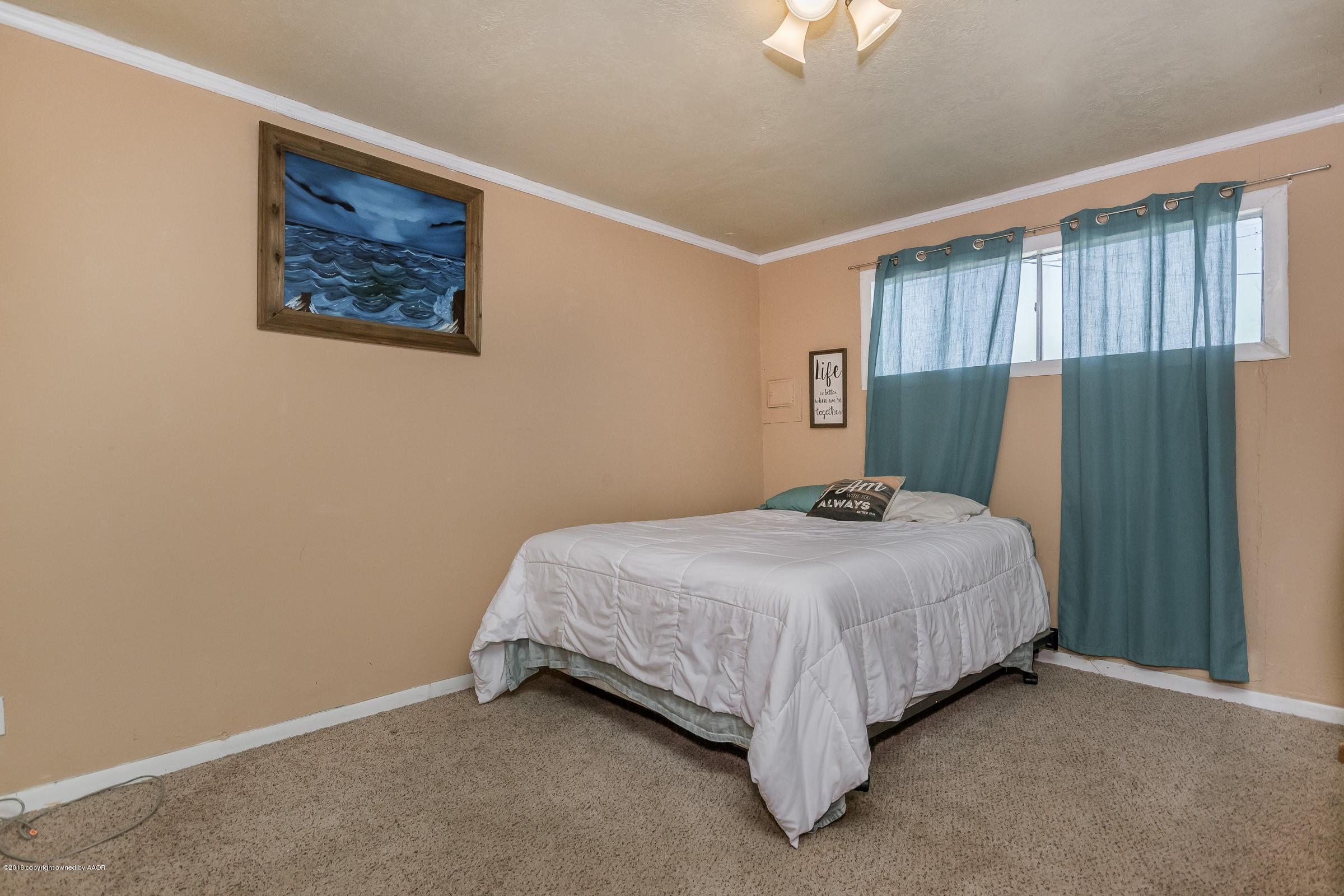 4635 South Hughes Street Amarillo, TX 79110 - Photo 10 of 20 a bedroom with a bed and a window
