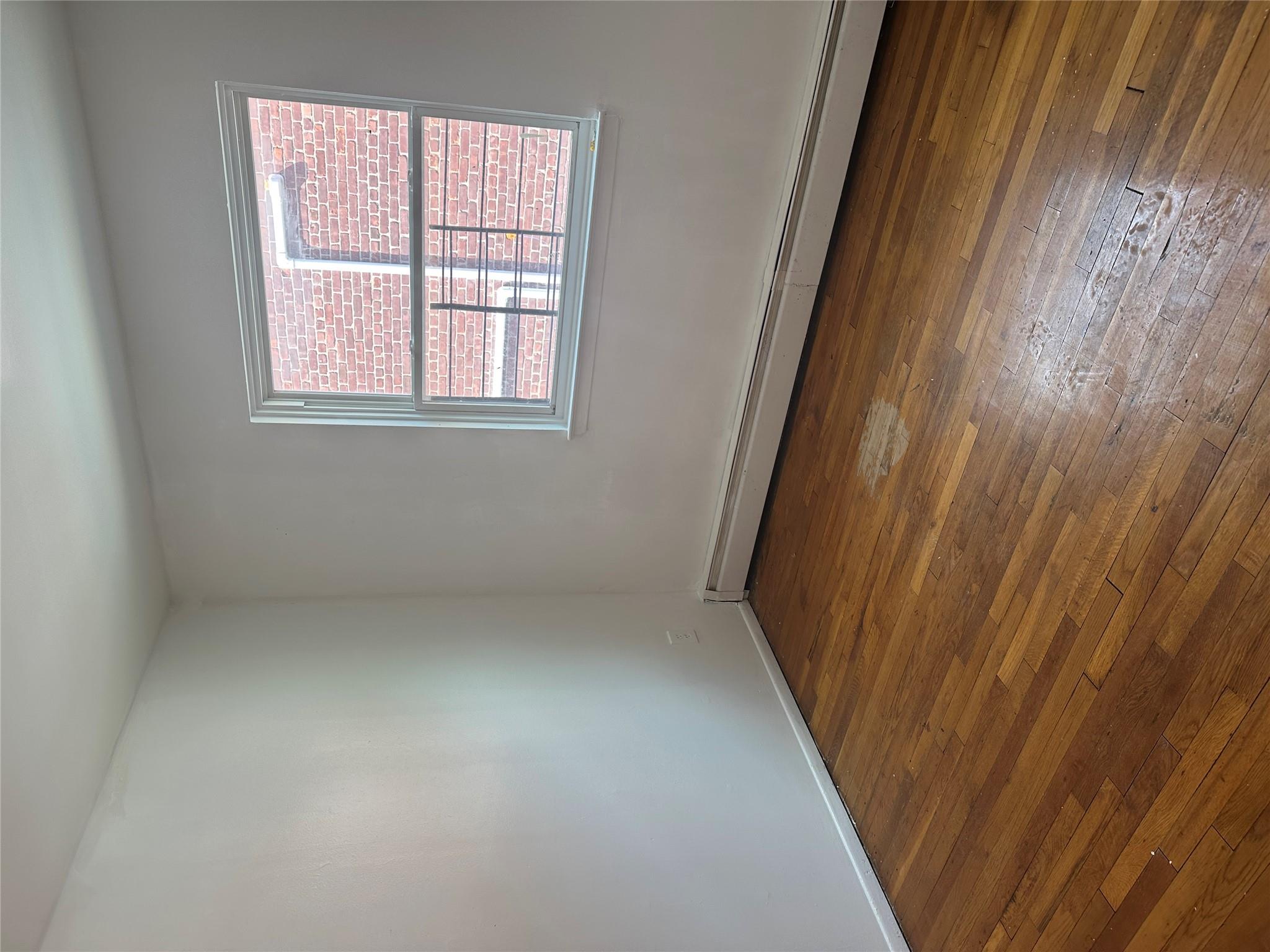 433 Howe Avenue, Unit A Bronx, NY 10473 - Photo 6 of 12 wooden floor in an empty room with a window