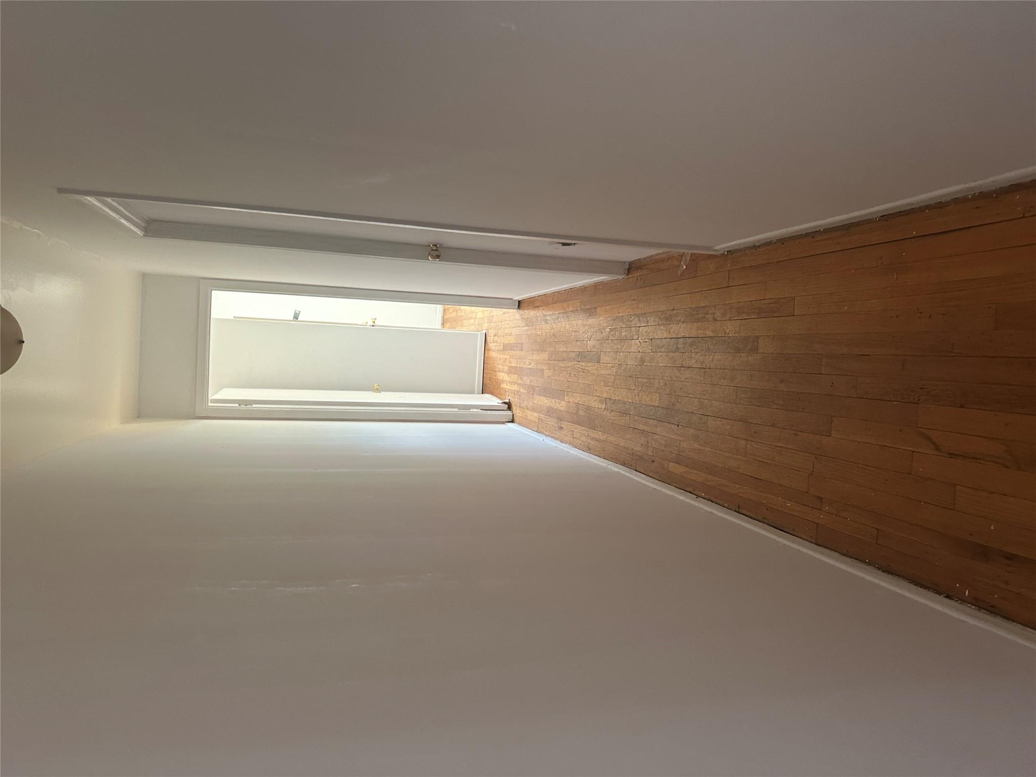433 Howe Avenue, Unit A Bronx, NY 10473 - Photo 7 of 12 a view of a hallway with wooden floor