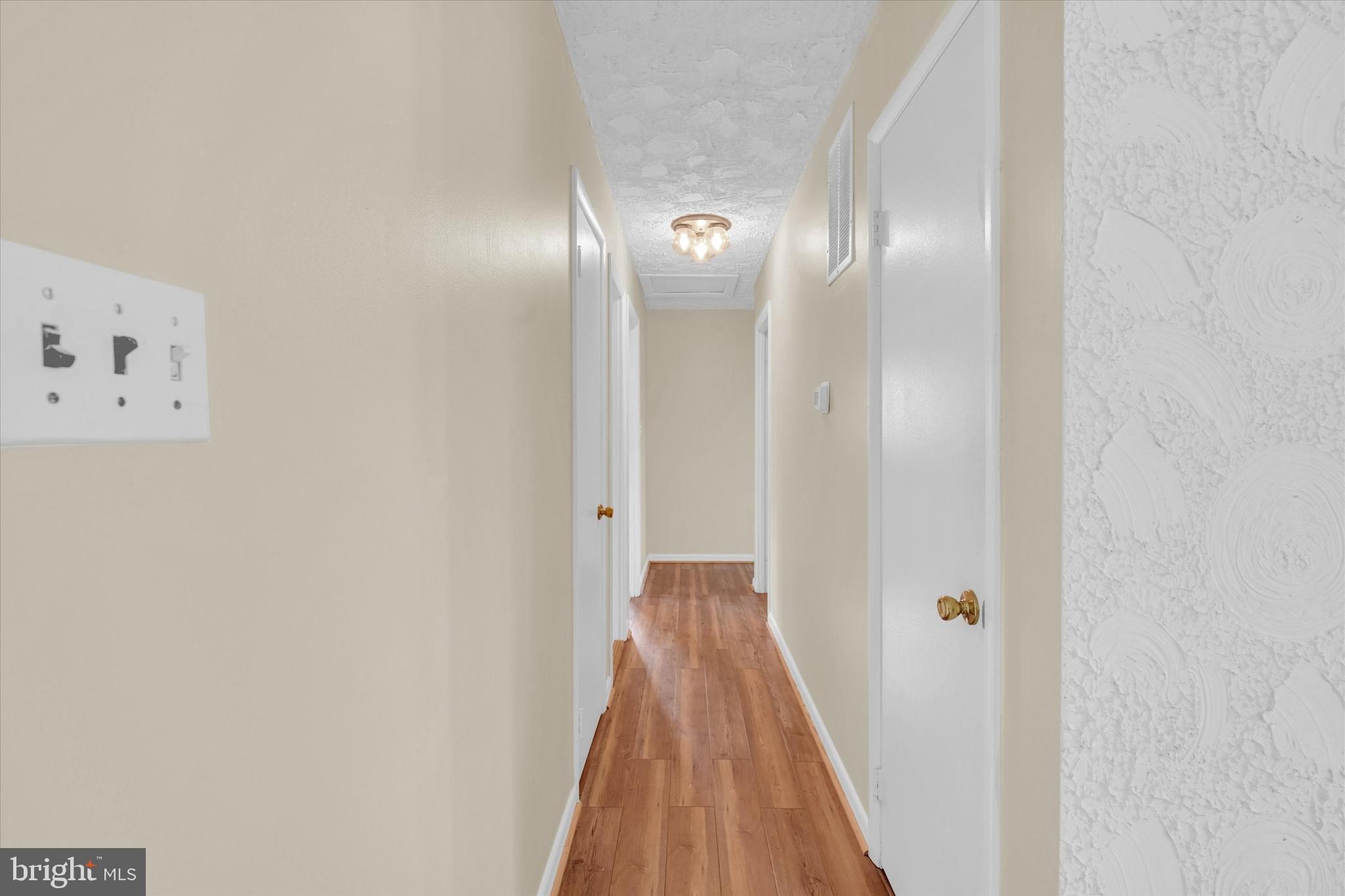 6812 Pepper Street Capitol Heights, MD 20743 - Photo 13 of 42 a view of a hallway with wooden floor