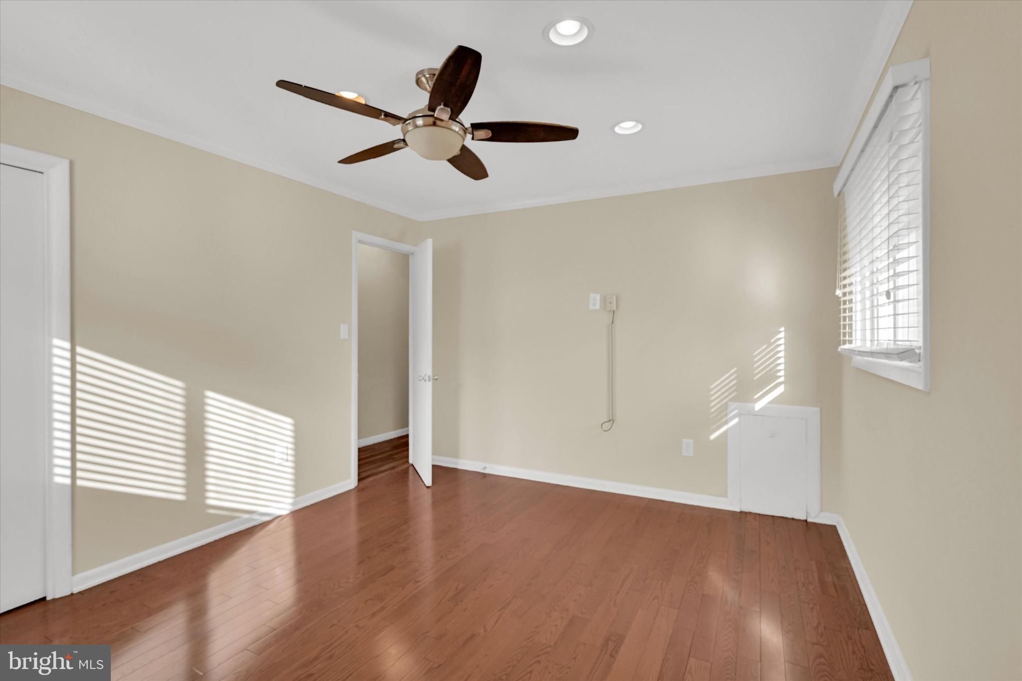 6812 Pepper Street Capitol Heights, MD 20743 - Photo 18 of 42 a view of an empty room with wooden floor and a window