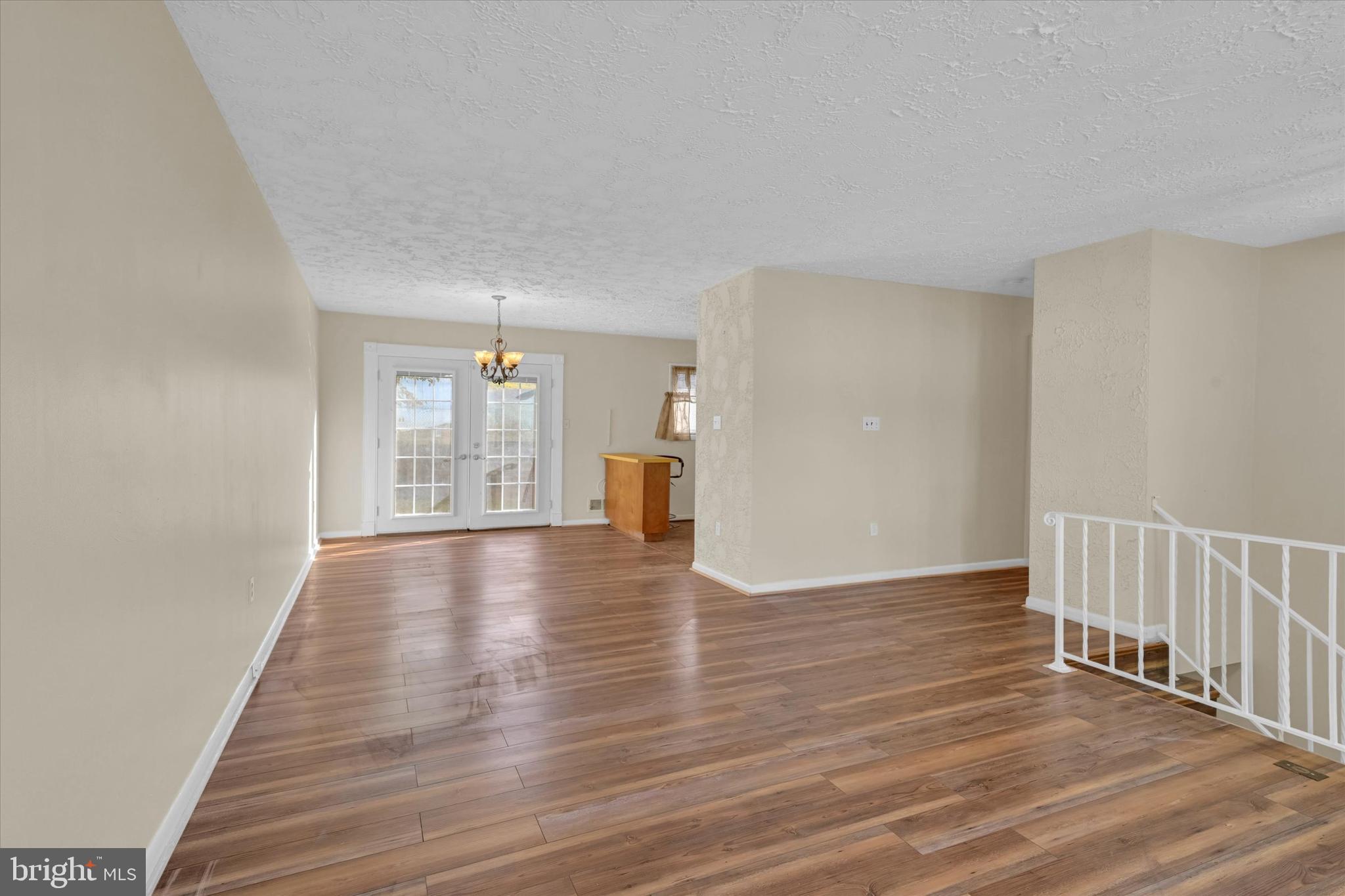 6812 Pepper Street Capitol Heights, MD 20743 - Photo 7 of 42 a view of an empty room with wooden floor and a window