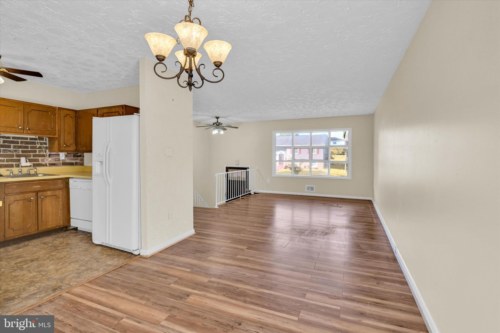 6812 Pepper Street Capitol Heights, MD 20743 - Photo 8 of 42 a view of an empty room with a window and wooden floor