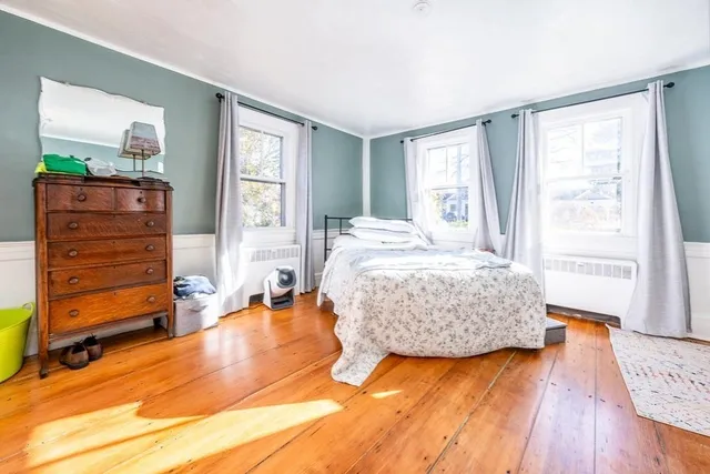 a living room with a fireplace and a table with wooden floor