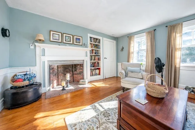 a living room with furniture fireplace and window