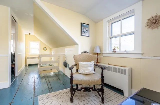 a bedroom with a bed mirror and window
