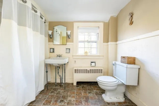 a bedroom with bed and window