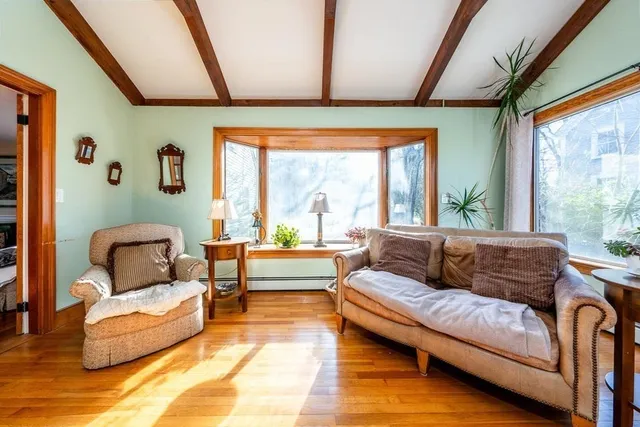 a view of a dining room with furniture and wooden floor