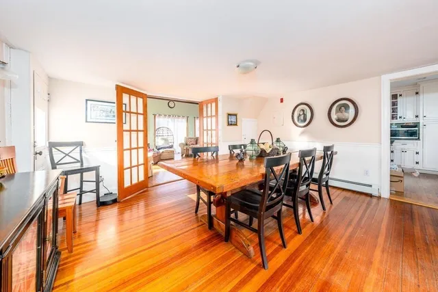 a dining room with furniture and wooden floor