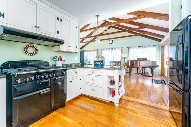 a kitchen with stainless steel appliances granite countertop a sink and cabinets