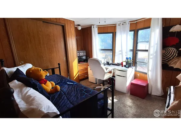 a living room with furniture and floor to ceiling window