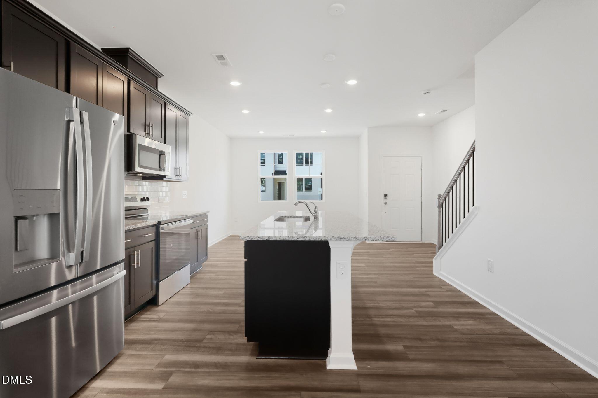 2309 Oakwood Mdws Court Raleigh, NC 27604 - Photo 12 of 34 a kitchen with stainless steel appliances granite countertop a refrigerator and a stove top oven
