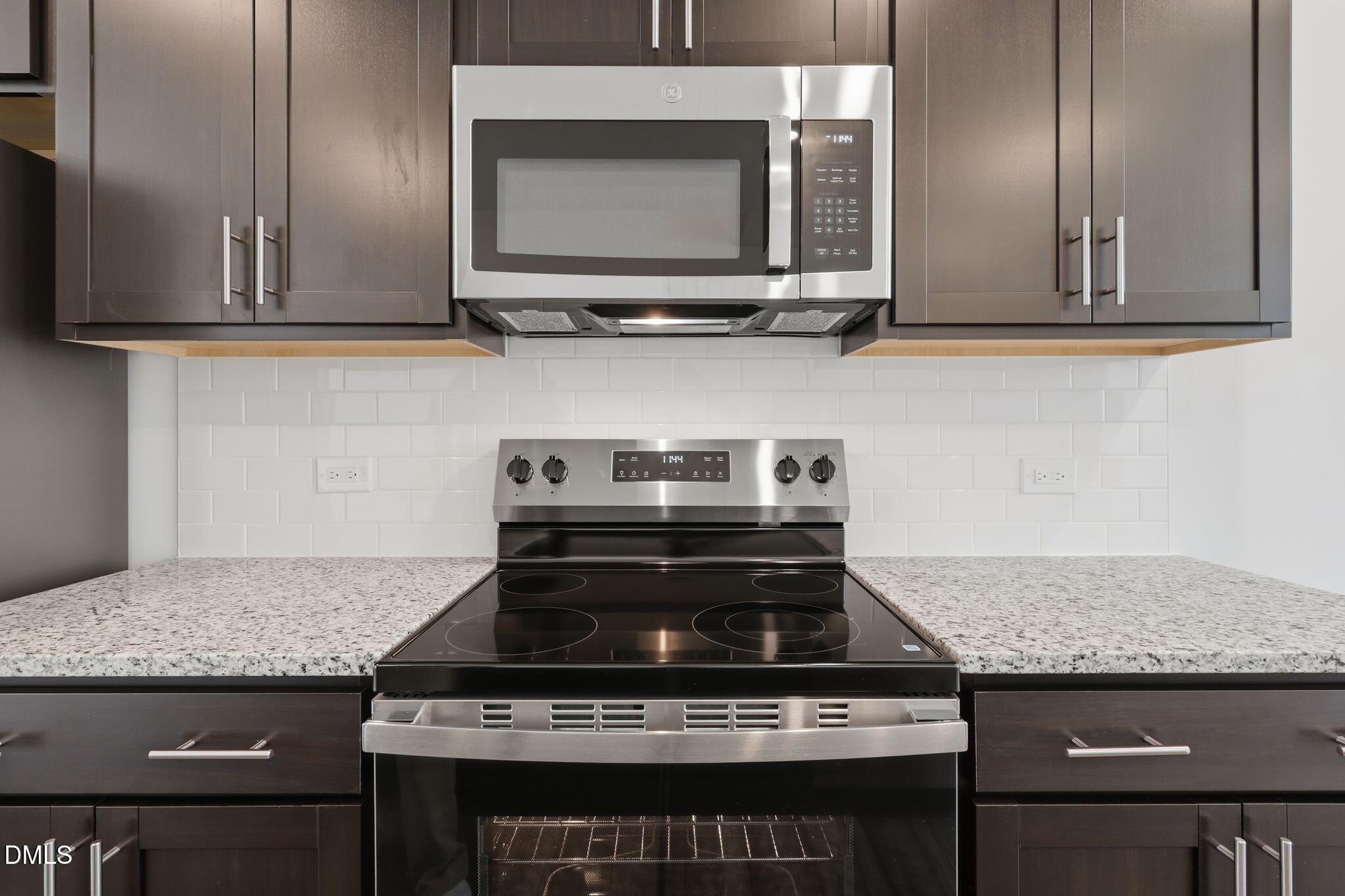 2309 Oakwood Mdws Court Raleigh, NC 27604 - Photo 14 of 34 a stove top oven sitting inside of a kitchen