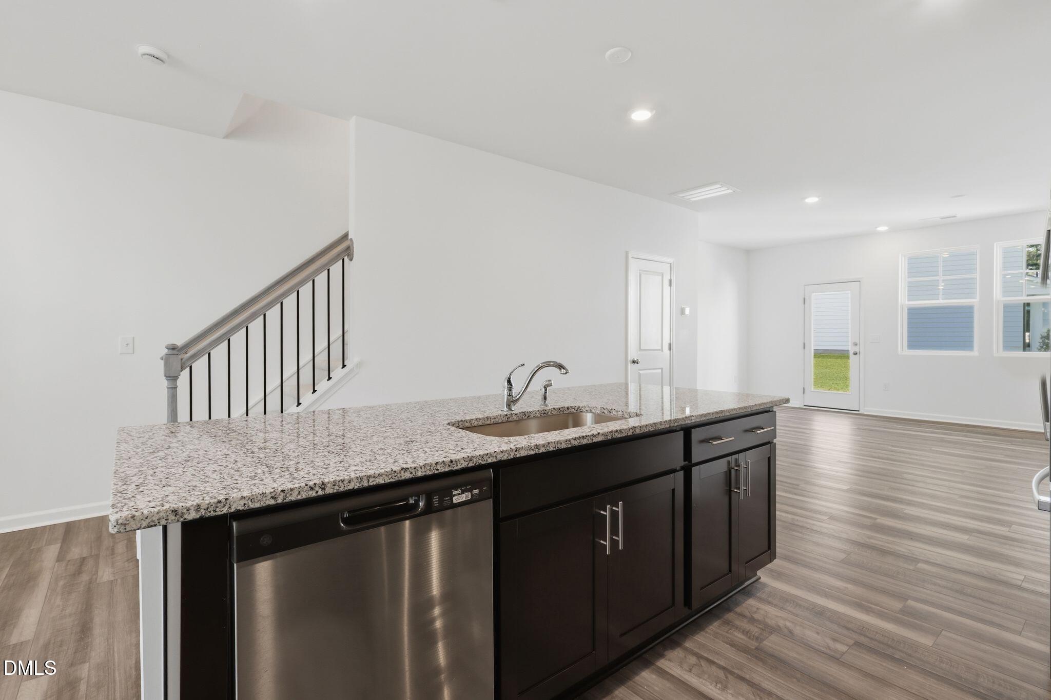 2309 Oakwood Mdws Court Raleigh, NC 27604 - Photo 15 of 34 a kitchen with granite countertop stainless steel appliances a sink and cabinets