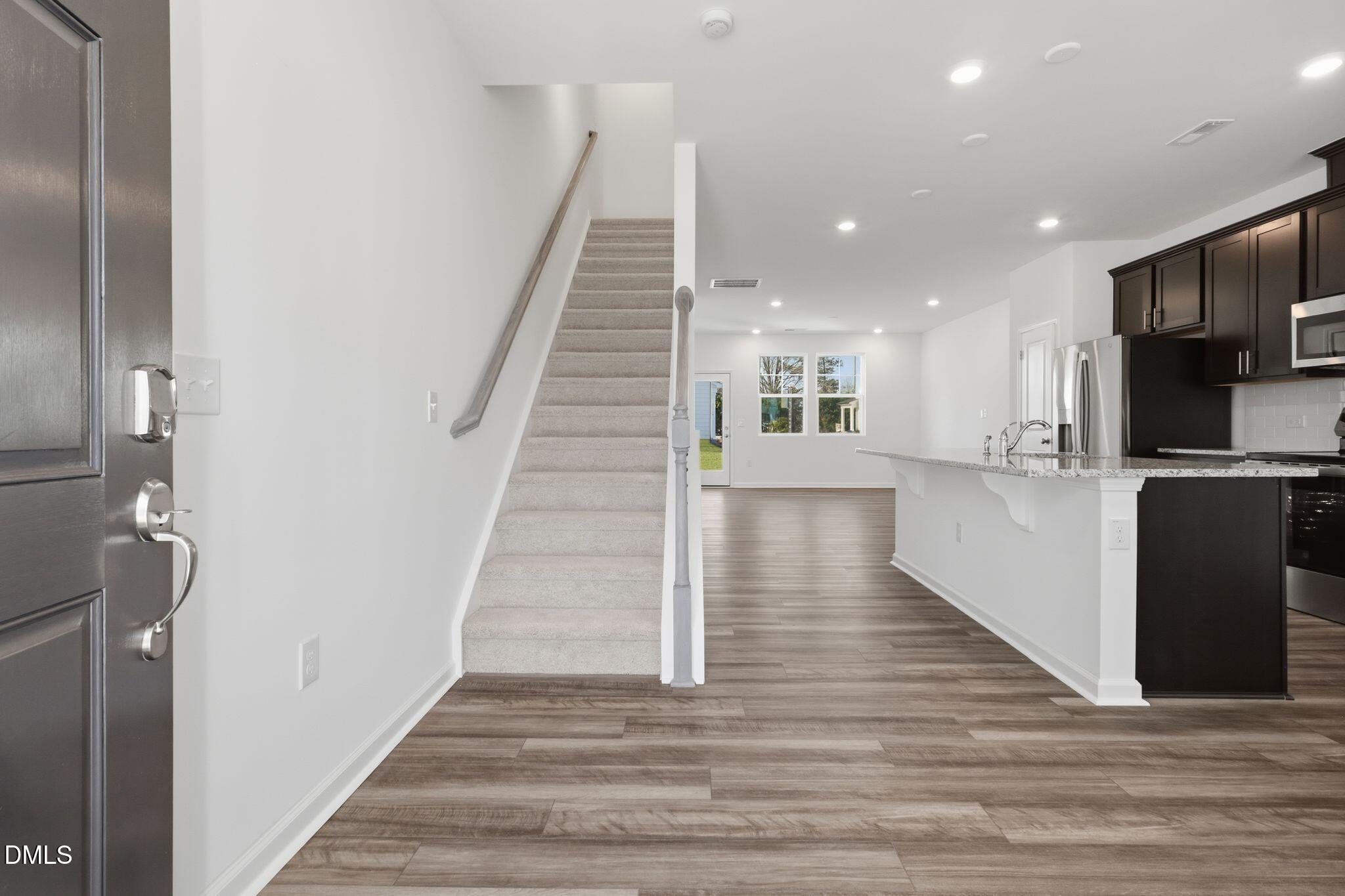 2309 Oakwood Mdws Court Raleigh, NC 27604 - Photo 17 of 34 a view of a hallway with wooden floor and staircase
