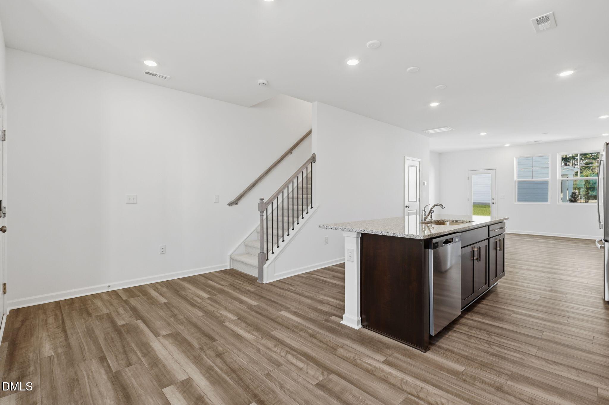 2309 Oakwood Mdws Court Raleigh, NC 27604 - Photo 19 of 34 a kitchen with wooden floors and cabinets