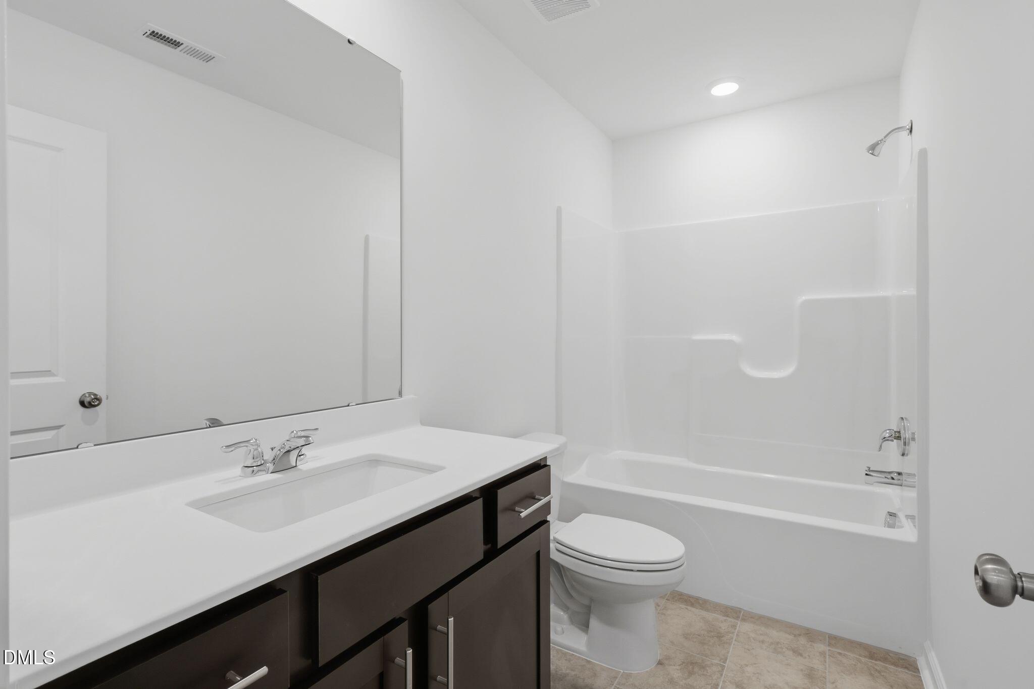 2309 Oakwood Mdws Court Raleigh, NC 27604 - Photo 23 of 34 a bathroom with a sink a toilet and shower