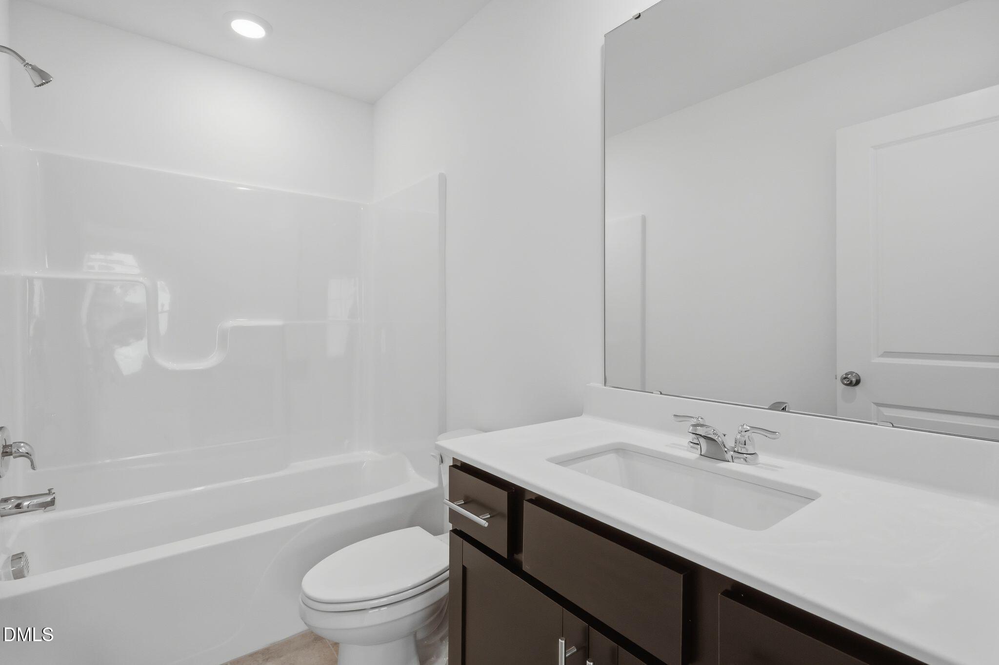 2309 Oakwood Mdws Court Raleigh, NC 27604 - Photo 24 of 34 a bathroom with a sink a toilet and a bathtub