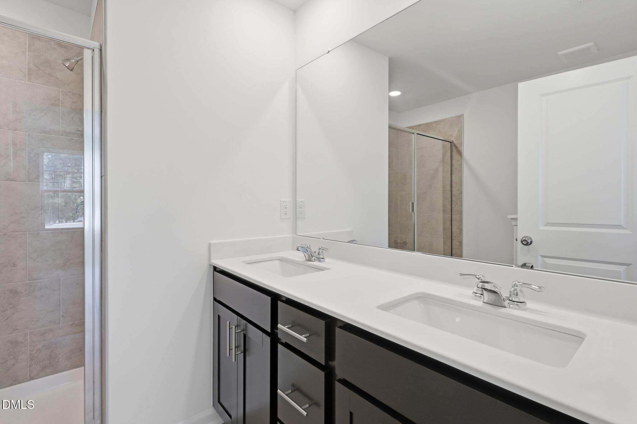 2309 Oakwood Mdws Court Raleigh, NC 27604 - Photo 32 of 34 a bathroom with a sink and a mirror