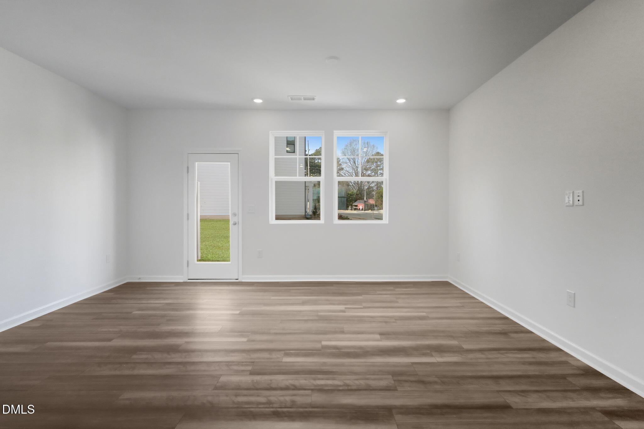 2309 Oakwood Mdws Court Raleigh, NC 27604 - Photo 8 of 34 a view of an empty room with a window and wooden floor