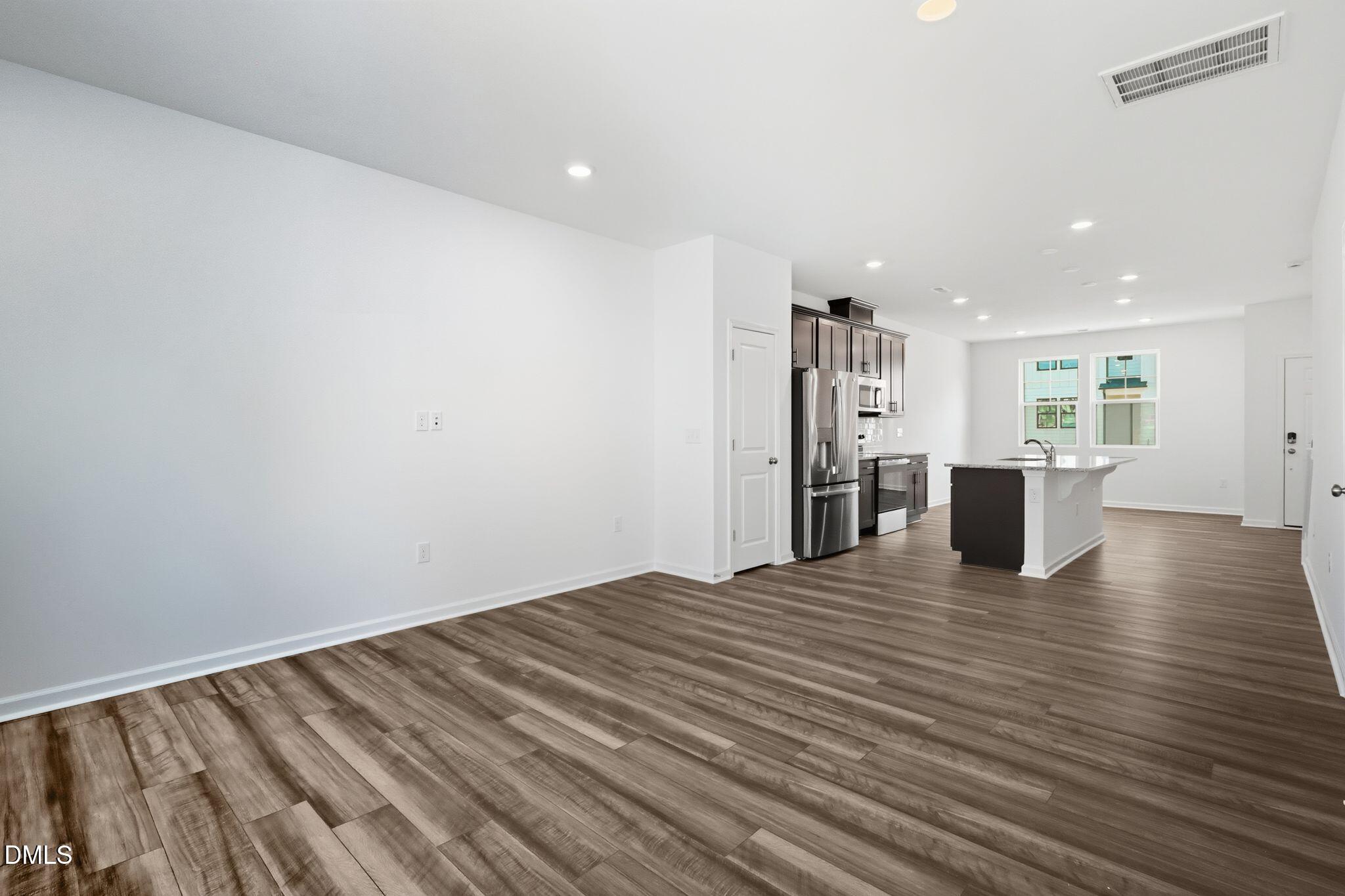 2309 Oakwood Mdws Court Raleigh, NC 27604 - Photo 9 of 34 a view of empty room with wooden floor
