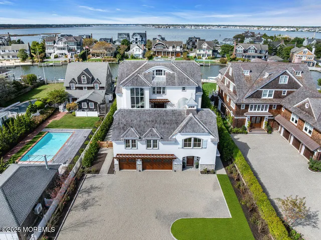 an aerial view of multiple houses with a yard