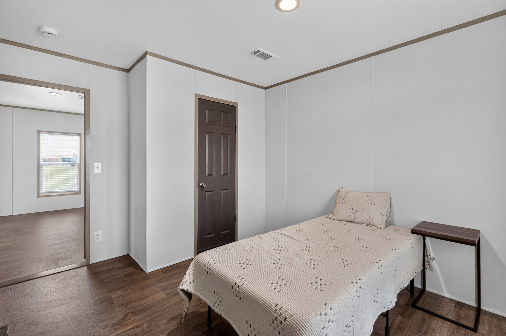 1134 Switchgrass Road Salado, TX 76571 - Photo 25 of 28 Hardwood-style flooring extends through this naturally lit bedroom, offering a warm and inviting atmosphere.