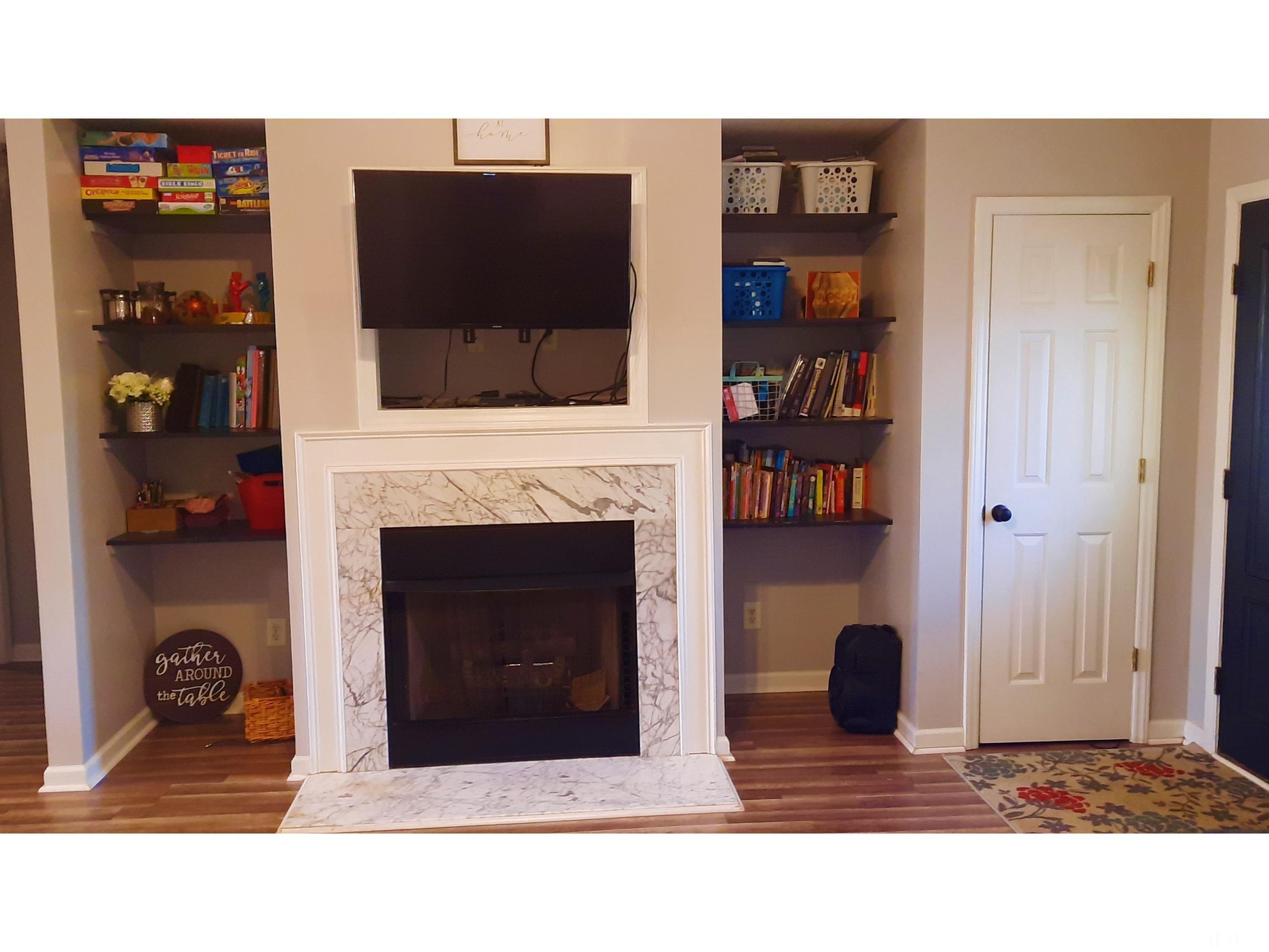 134 Collin Drive Roxboro, NC 27574 - Photo 18 of 31 a black and white living room with a fireplace