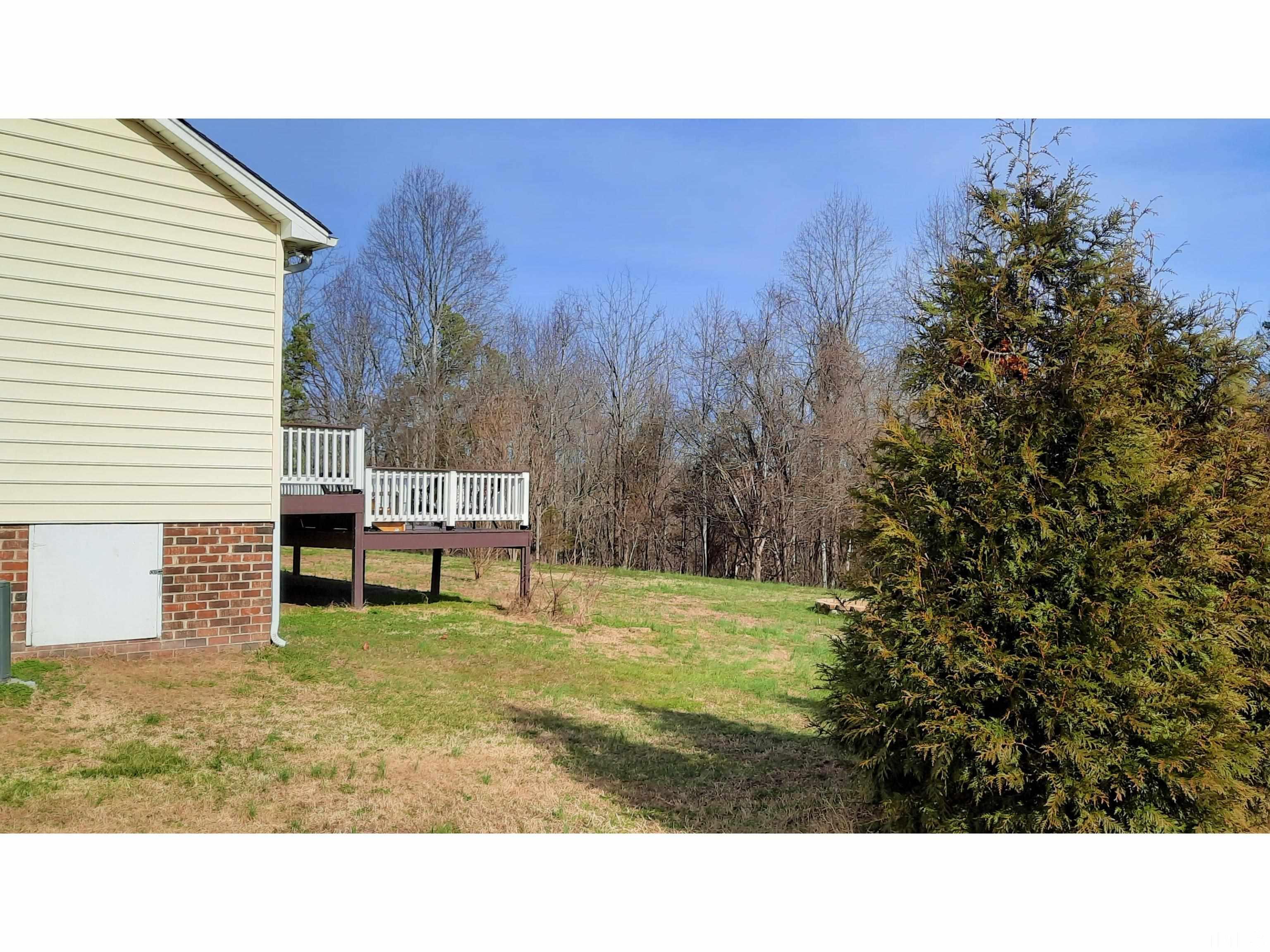 134 Collin Drive Roxboro, NC 27574 - Photo 6 of 31 a backyard of a house with table and chairs