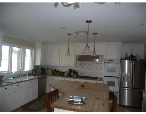 a kitchen with a refrigerator a sink and cabinets
