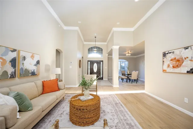 a living room with furniture and a chandelier