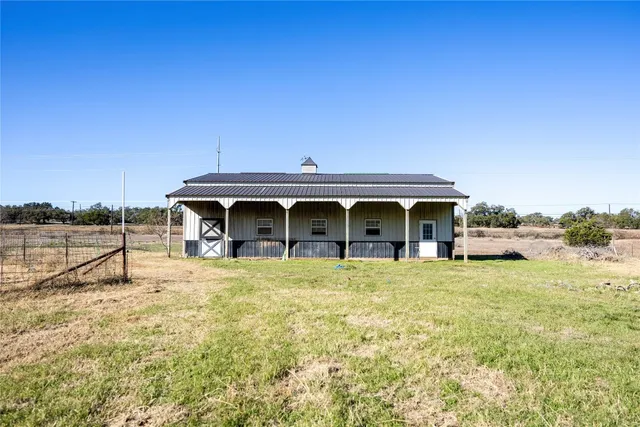 a view of a house with garden yard and deck