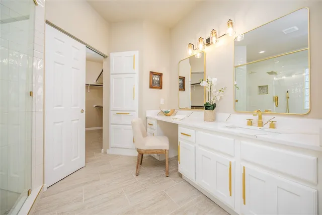 a spacious bathroom with a shower sink and a mirror