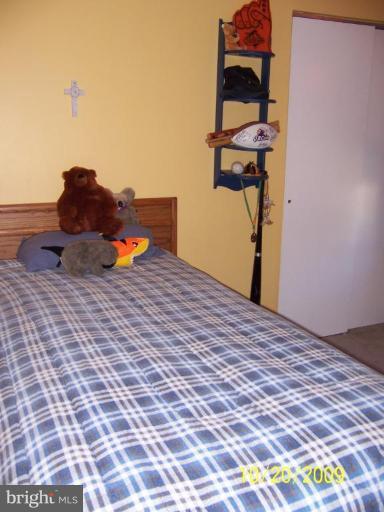 9417 Gunview Road Nottingham, MD 21236 - Photo 12 of 30 a bedroom with a bed and a painting on the wall