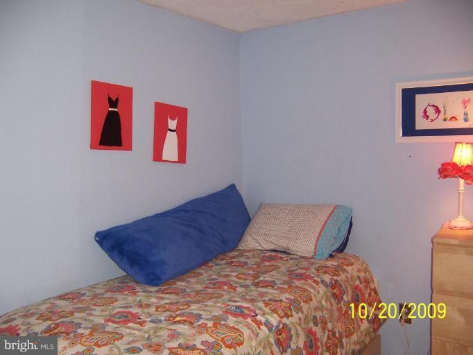 9417 Gunview Road Nottingham, MD 21236 - Photo 20 of 30 a bedroom with a bed and a painting on the wall