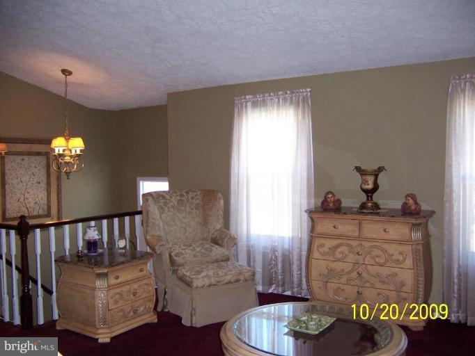 9417 Gunview Road Nottingham, MD 21236 - Photo 3 of 30 a living room with furniture and a chandelier